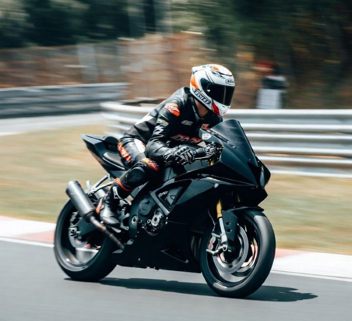 motorcycle racer leaning into a curve
